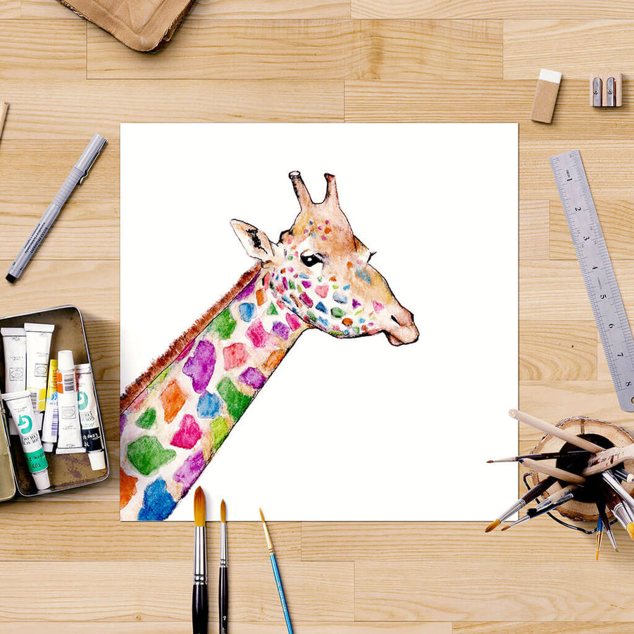 Giraffe painting on desk with art supplies